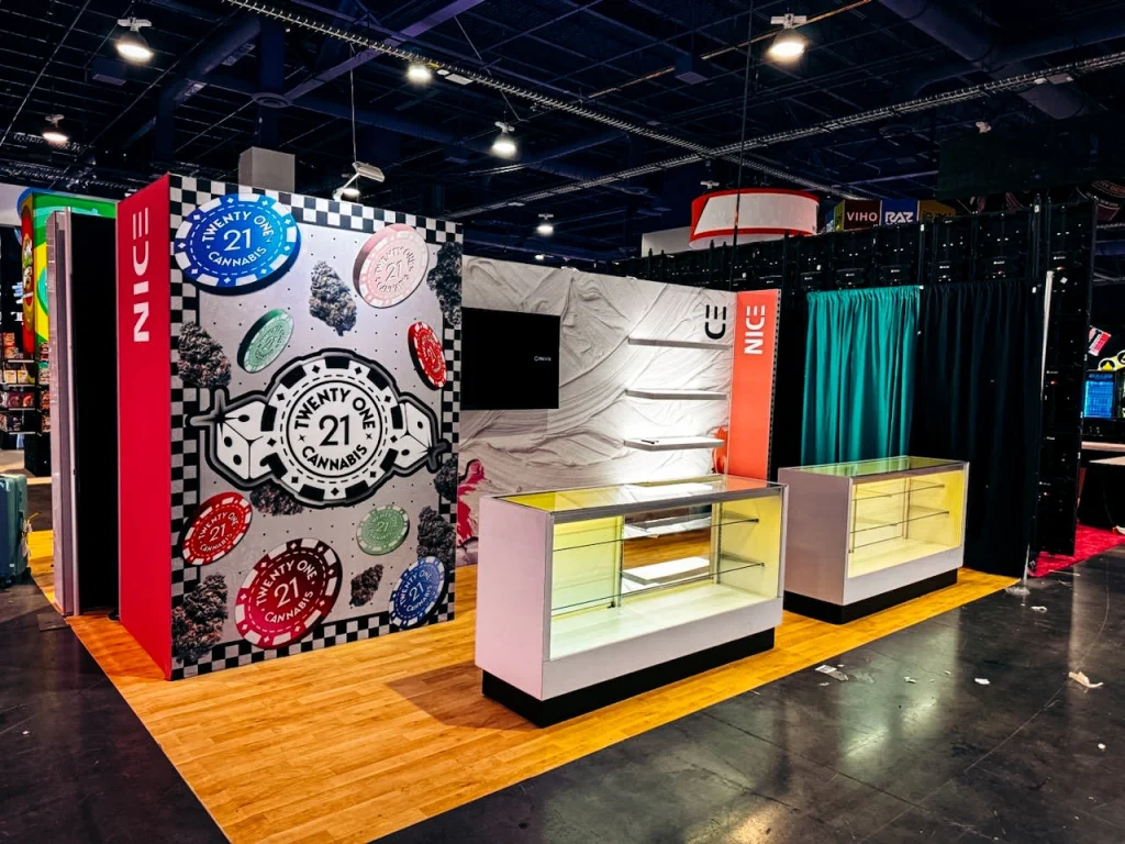 A cannabis trade show booth featuring colorful emblems, showcasing the expertise of trade show exhibit builders in Miami.