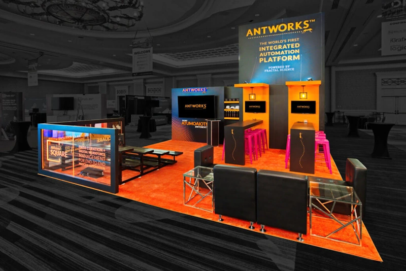 A custom trade show displays featuring the ANTWORKS integrated automation platform with orange and black decor.