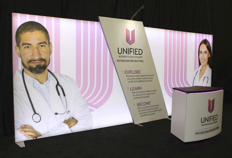 Custom trade show displays Fort Lauderdale featuring medical professionals, Unified Women's Healthcare branding, and recruiting information.