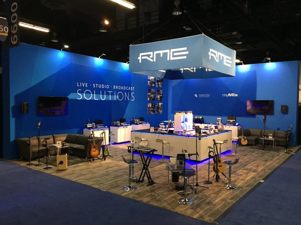 RME trade shows in miami with blue backdrop and display of musical equipment.