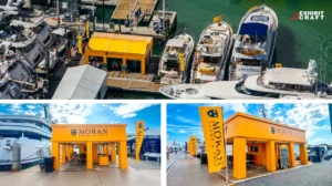 Orange booth on a dock with moored yachts representing Miami international boat show 2026