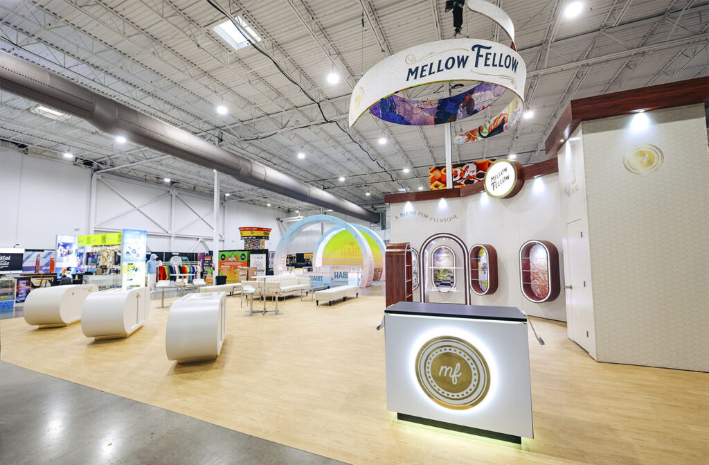 A modern "Mellow Fellow" exhibit booth constructed from modular trade show displays by Exhbit Craft