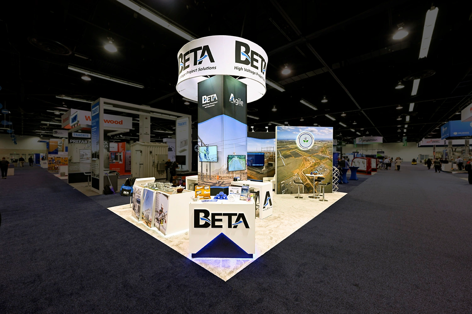 A custom island booth design for Beta Engineering at a trade show convention center.